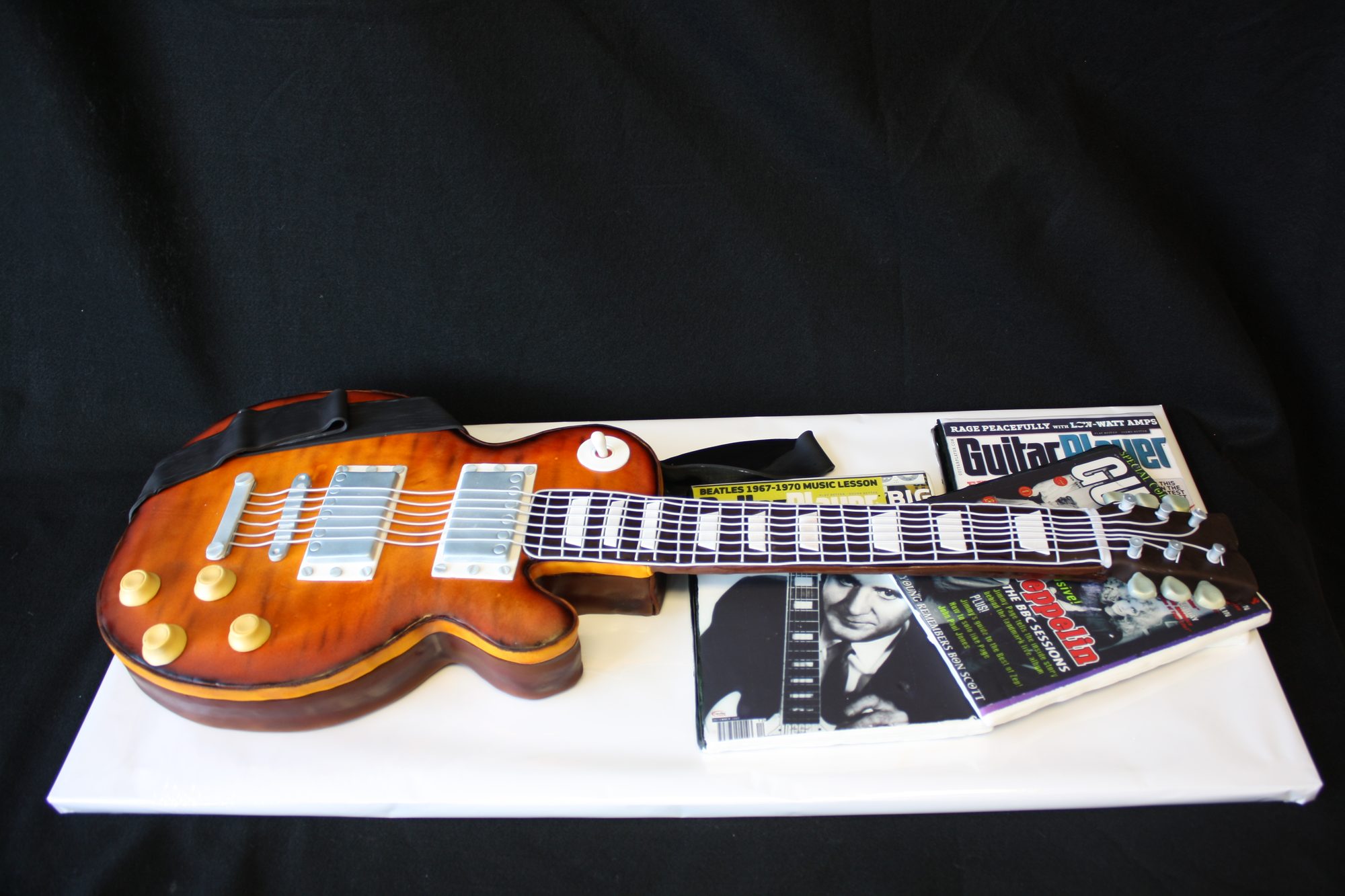 Les Paul guitar cake with guitar magazines
